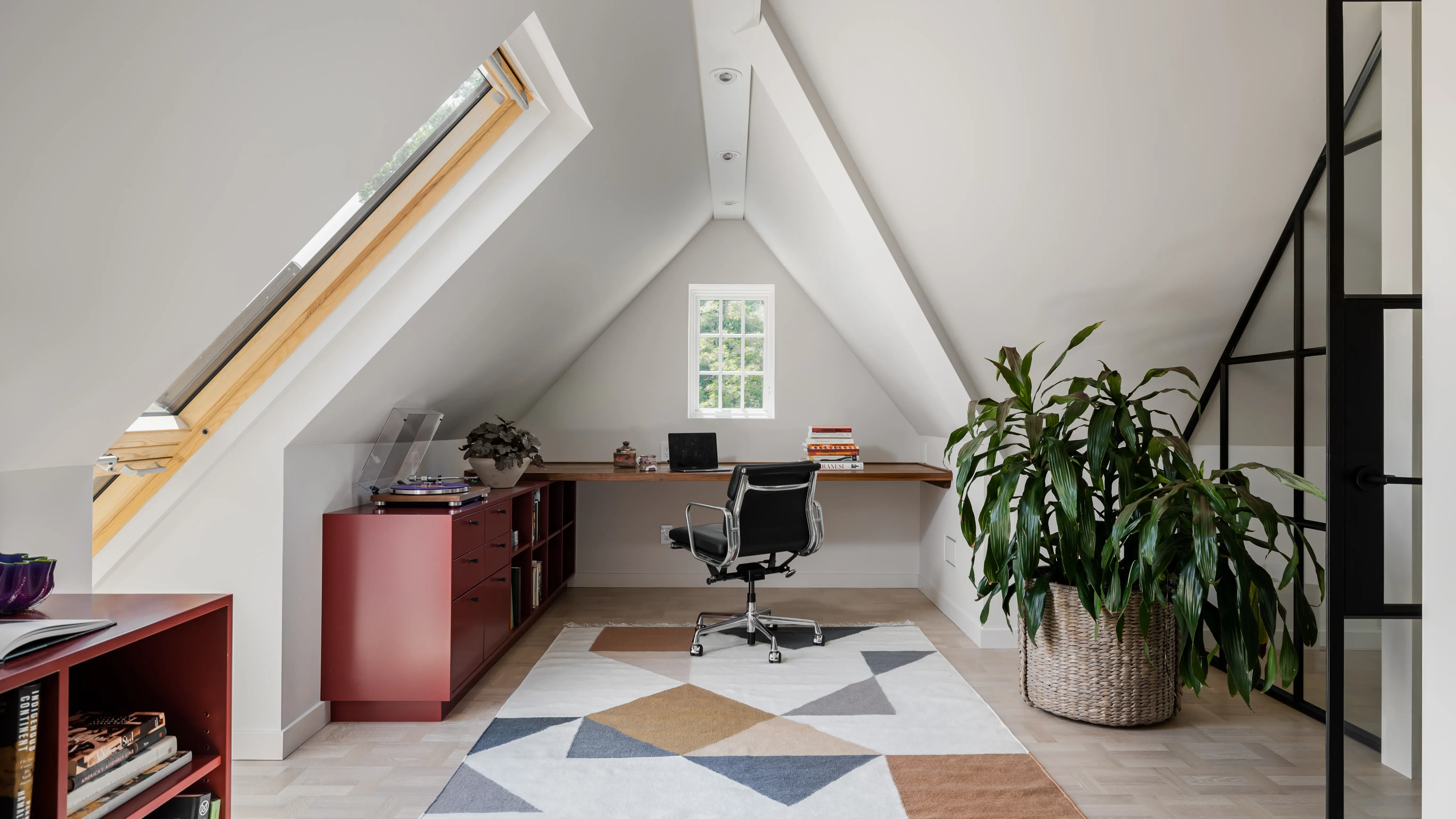 Minimal architectural workspace with desk, monitor, and organized zones
